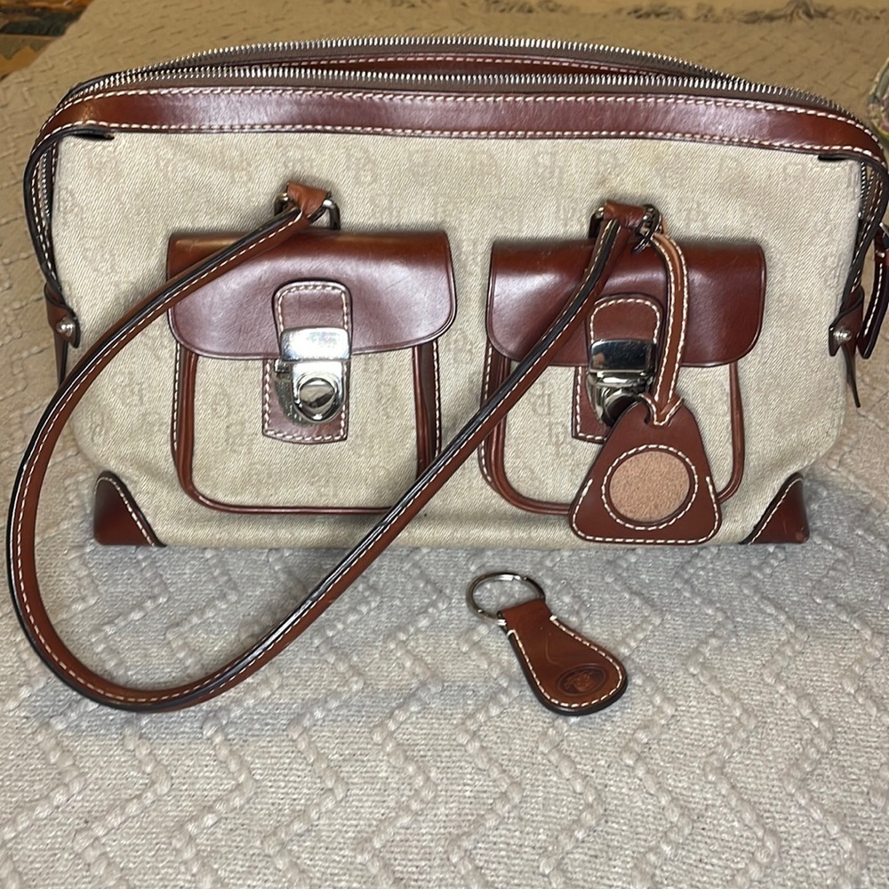 Dooney & Bourke Double Pocket Tote Purse in brown colored monogram.